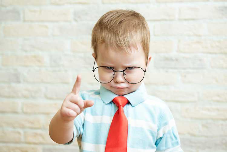Toddler wearing a tie and glasses.